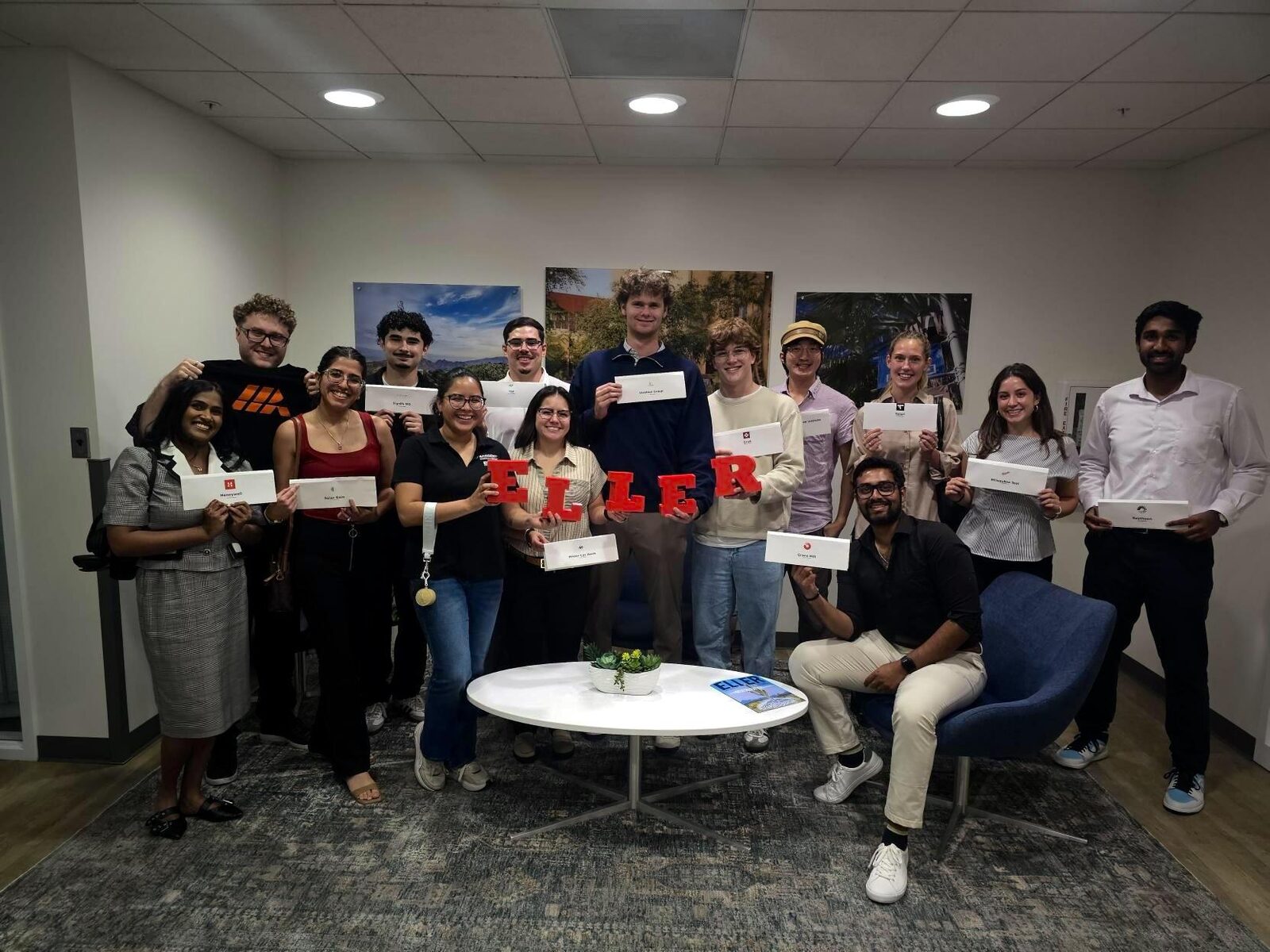 Group photo holding up letters that spell Eller