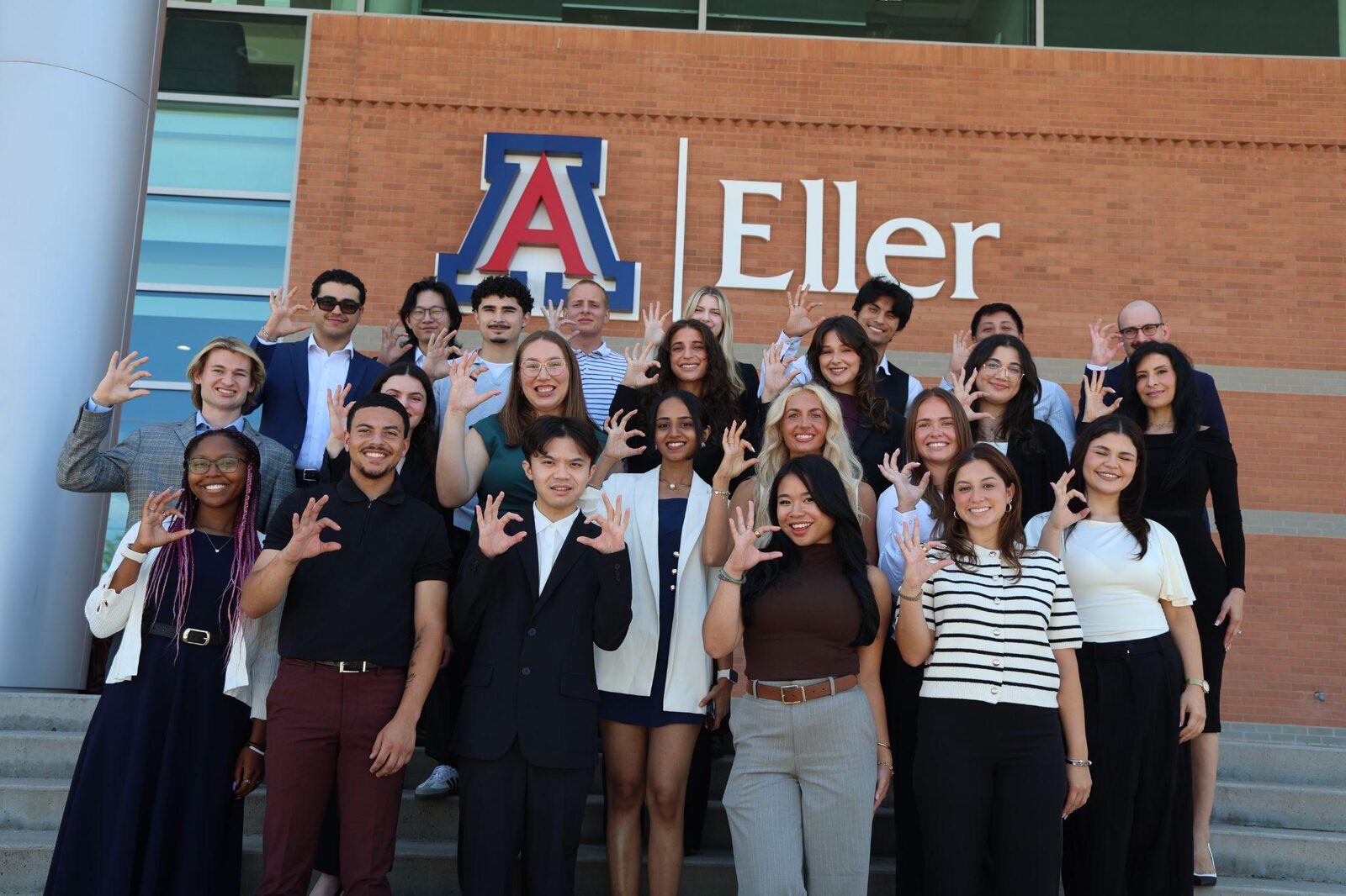 Group photo in front of the Eller College of Management sign