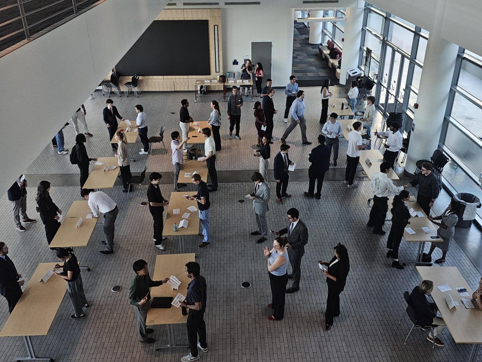 Overhead view of people at tables in a large atrium